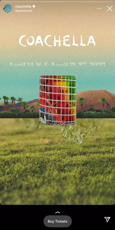 A colorful cylindrical art installation stands in a field with palm trees and mountains in the background. Text reads, "Coachella April 14-16 & April 21-23, 2023.