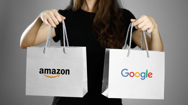 A person in a black shirt holds two shopping bags, one with the Amazon logo and the other with the Google logo, against a plain background.