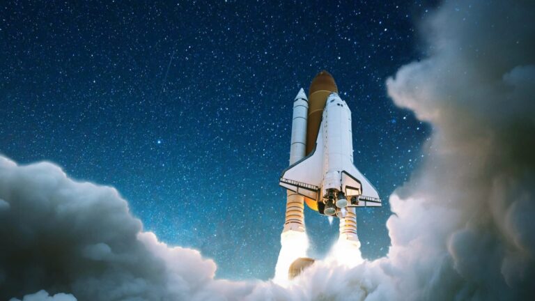 A space shuttle launches into a starry night sky, emitting bright flames and surrounded by clouds of smoke.