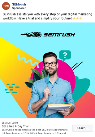 A man with glasses holds a pencil and a notepad, standing in front of colorful geometric shapes and the SEMrush logo, promoting a free 7-day trial for a digital marketing tool.